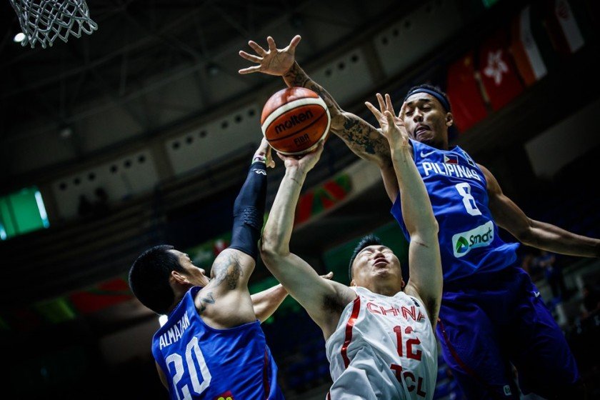 Raymond Almazan (L) and Calvin Abueva (R) of the Philippines smother Gen Li of China | FIBA photo