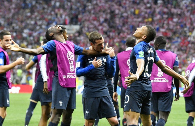 France's Kylian Mbappe, right, celebrates after scoring his side's fourth goal during the final match between France and Croatia at the 2018 soccer World Cup in the Luzhniki Stadium in Moscow, Russia, Sunday, July 15, 2018. (AP Photo/Martin Meissner)
