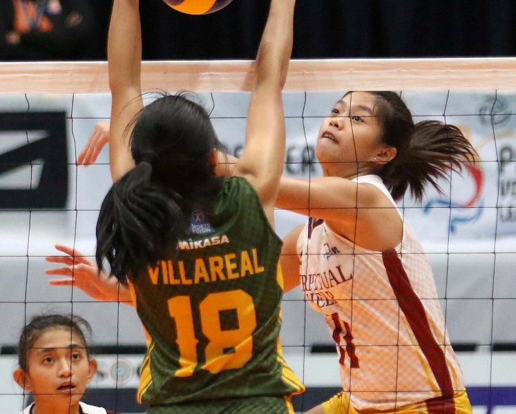 FEU’s Virginia Villareal foils Perpetual Help’s Kate Llorente’s attack during their PVL Collegiate Conference clash at the Filoil Flying V Center.