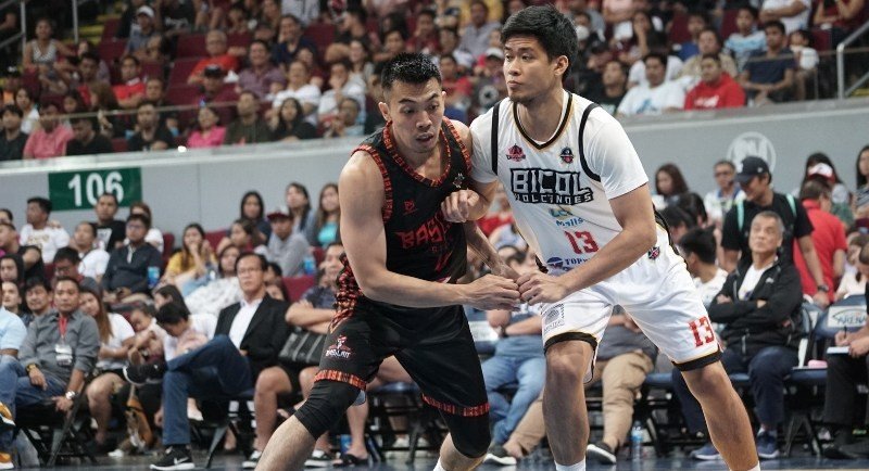 Bobby Balucanag of the Basilan Steel and JR Ontenggo of the Bicol Volcanoes jockey for position during a rebound play.