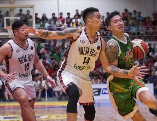 Josan Nimes of Pasig drives hard to the basket against two Nueva Ecija defenders.