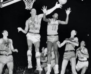 Earl Lloyd (in white jersey) goes for a rebound.