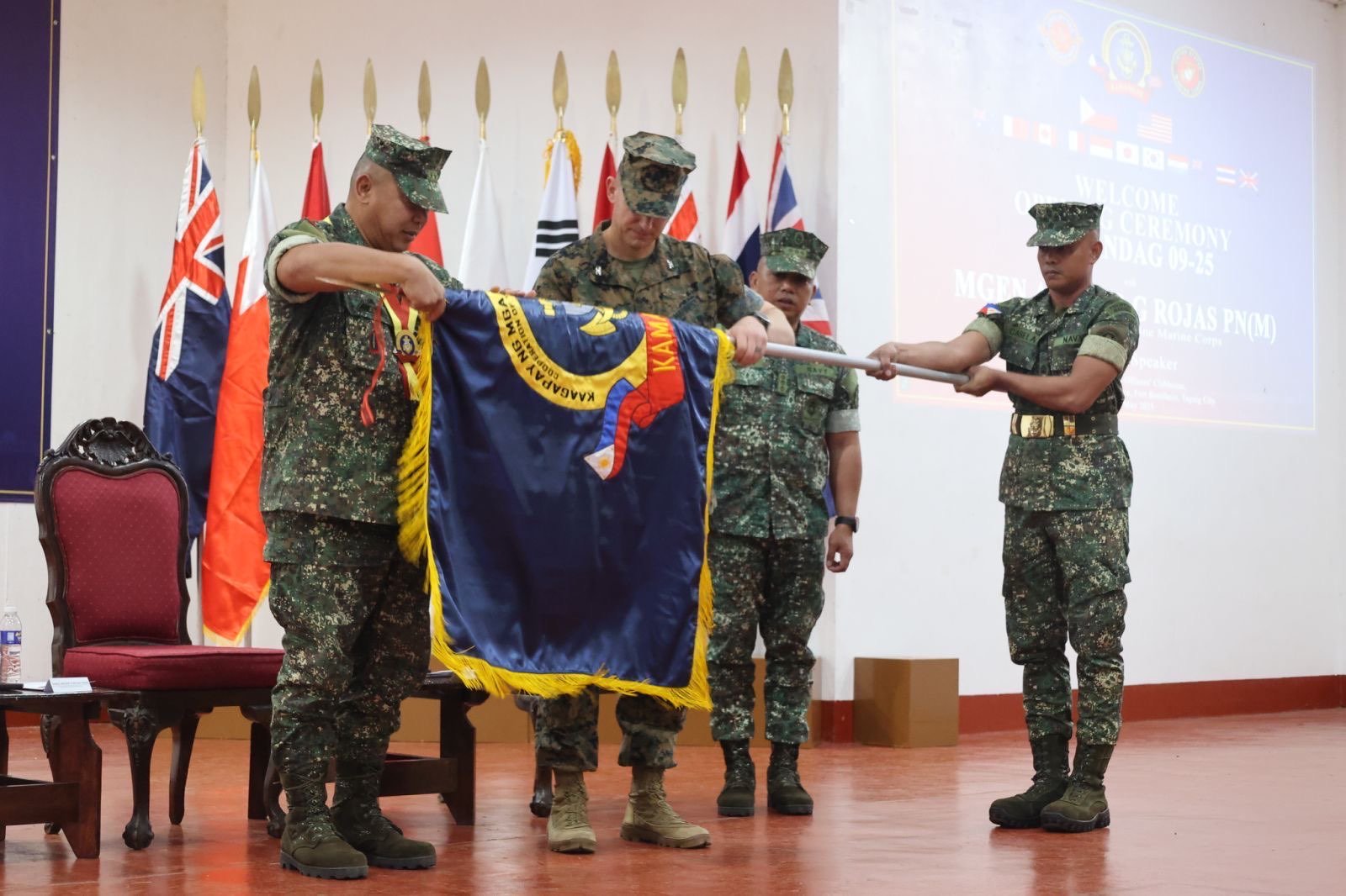 Military leaders from five nations salute during the opening ceremony of KAMANDAG 9.
