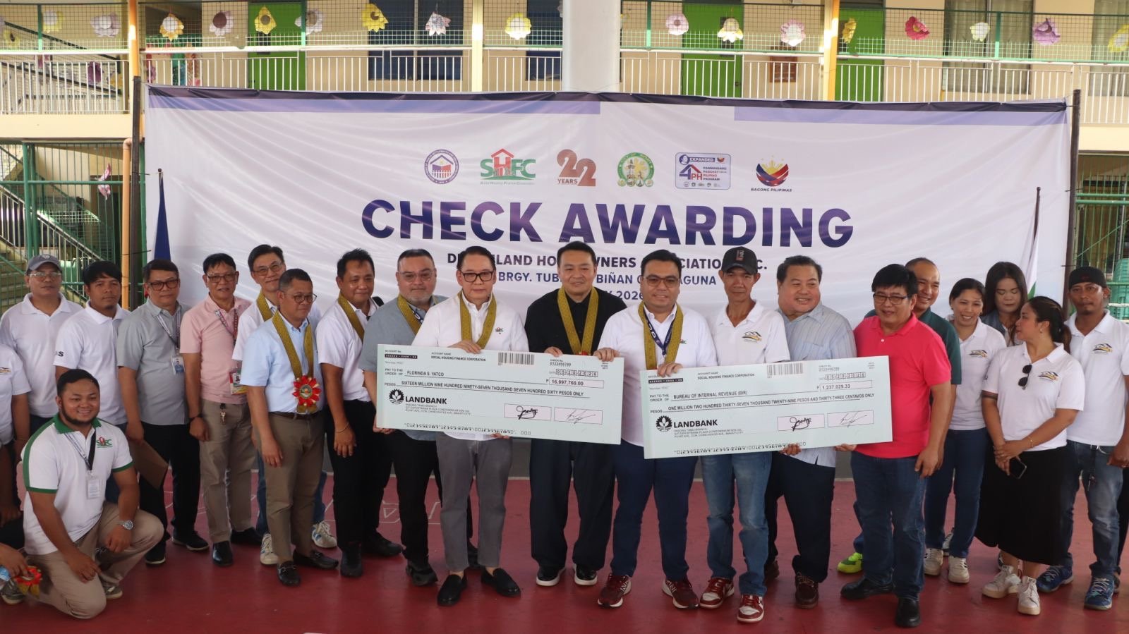 SHFC and DHSUD officials lead the turnover of housing assistance in Biñan City.