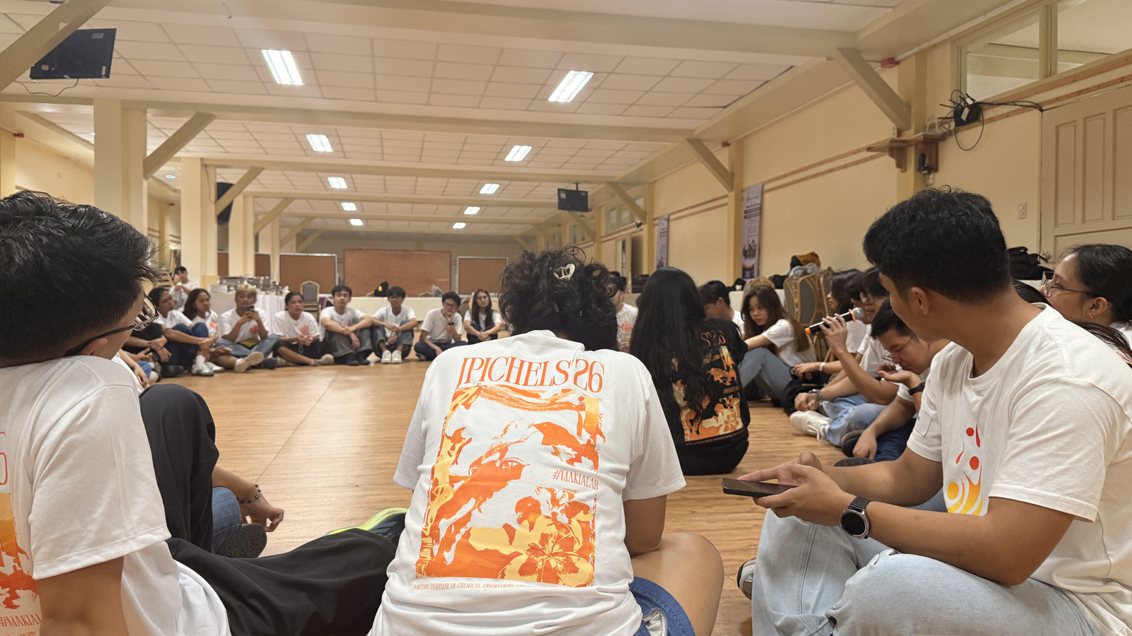 Delegates join a reflection huddle to process insights and lessons from the team‑building activities.