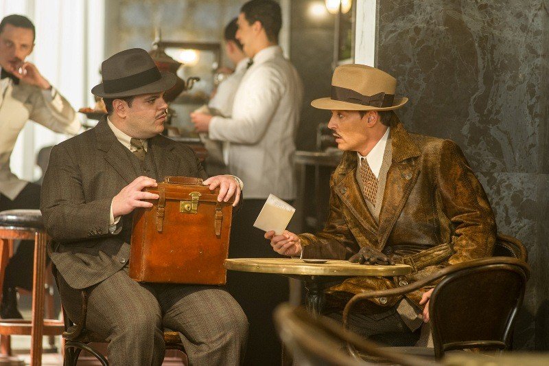 Josh Gad, left, and Johnny Depp star in Twentieth Century Fox’s “Murder on the Orient Express.”