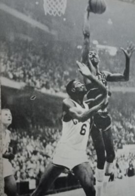 Wilt Chamberlain, playing for the Philadelphia (now Golden State) Warriors, scores off his Boston Celtics counterpart Bill Russell during the 1960 NBA East final playoffs.