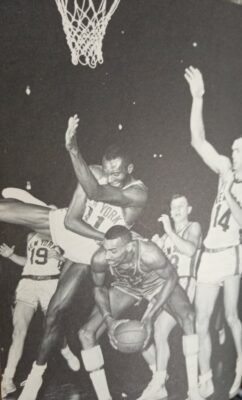 Philadelphia's Wilt Chamberlain draws a foul from New York's Johnny Green. Wilt owned a pair of 50-point games against the Knicks during the 1961 Yuletide holidays with the two teams going 1-1.
