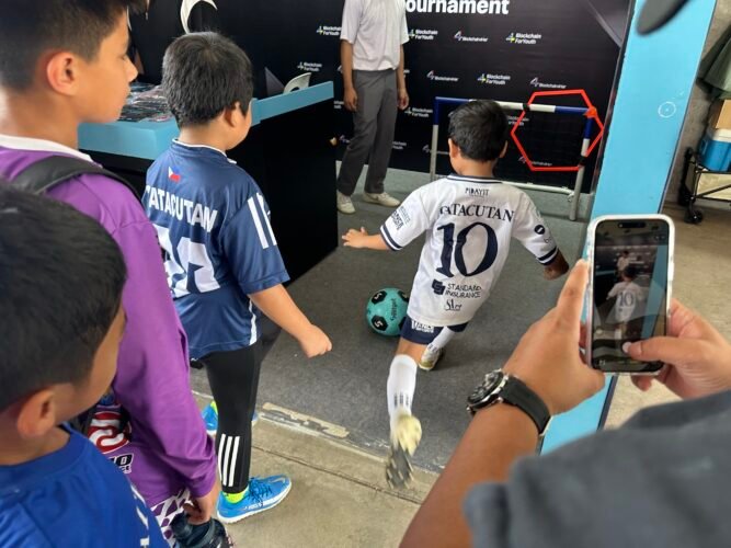 Children enjoy a penalty shoot-out at Bitget’s Blockchain4Youth booth during La Liga’s Youth Tournament.