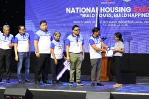 President Marcos, Jr., along with DHSUD Secretary Aliling, SHFC President and CEO Laxa, and other key shelter during the awarding of certificates of lot award to ECMP beneficiaries