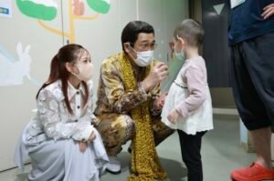 Pikotaro engages with children through charity outreach activities.