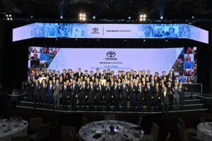 Group photo of TMP executives and dealer awardees commemorating 2025 achievements.