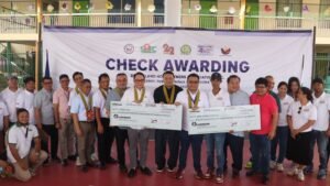 SHFC and DHSUD officials lead the turnover of housing assistance in Biñan City.