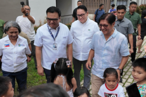 Government officials accompany President Marcos during his inspection of the People's Ville development.