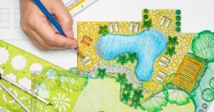 A close-up of a person drawing a colorful backyard pool and landscaping plan with rulers, templates, and a compass.