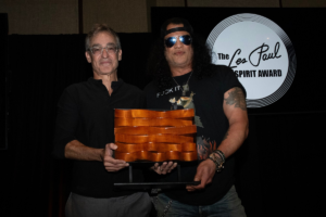 Slash received the 2026 Les Paul Spirit Award in Hollywood, with a trophy crafted from acoustic boards Les Paul made for his home recording studio. [photo credit: Julia Lofstrand]