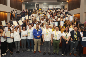 The Community Mortgage Program helped 91 families from Quezon City and Caloocan receive Transfer Certificates of Title through an awarding ceremony led by SHFC and DHSUD.